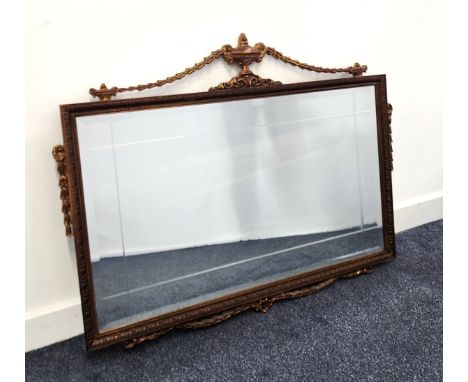 RECTANGULAR WALL MIRRORwith a textured wood frame surmounted with an urn and garlands, with a bevelled plate, 76cm x 98cm 