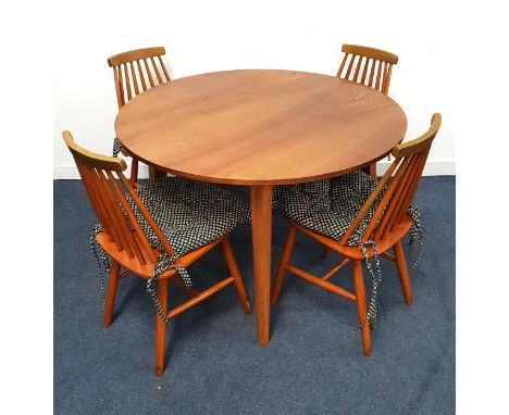 ELM CIRCULAR DINING TABLE AND FOUR CHAIRSthe table standing on tapering supports, 107cm diameter, together with four stick ba