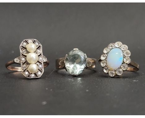 AQUAMARINE SINGLE STONE RINGon silver shank with decorative leaf decorated shoulders, ring size N; together with two further 