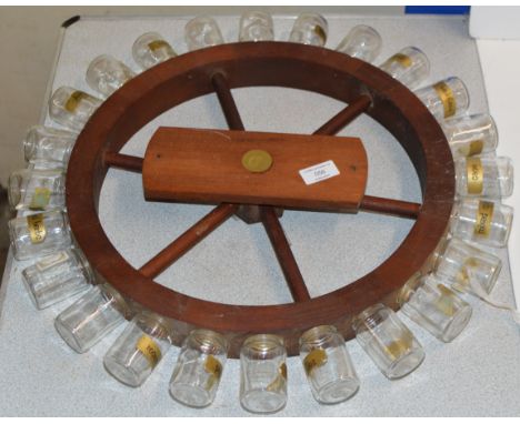A NOVELTY WOODEN SHIPS WHEEL SPICE RACK     