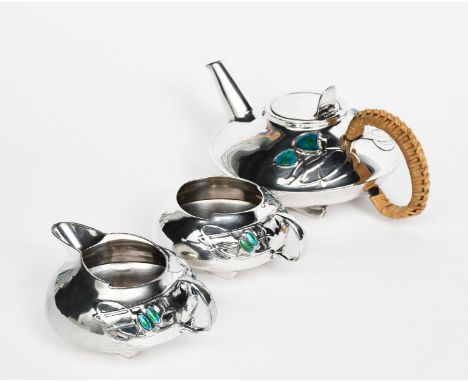 A Liberty &amp; Co English Pewter and enamel three piece tea set designed by Archibald Knox,  model no.0231, low compressed f