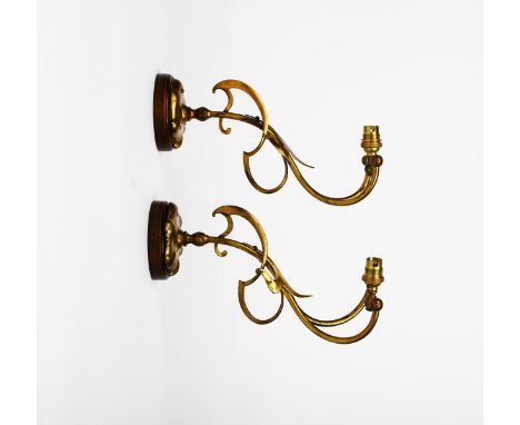 A pair of Art Nouveau patinated metal twin-branch wall lights, flowerhead bracket supporting splitting  rod stem entwined wit