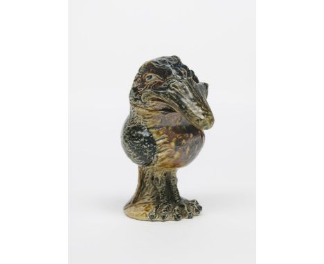 A Martin Brothers stoneware bird jar and cover by Robert Wallace Martin, the small, rotund bird modelled with upcast knowing 