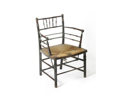 An ebonised wood Sussex chair in the manner of Morris &amp; Co,  with turned legs,  bobbin back and rush seat 78cm. high