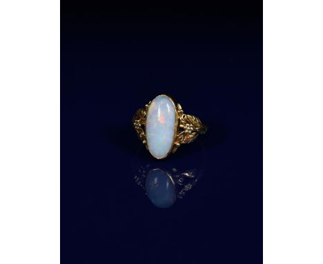 A gold and opal ring probably by the Artificers Guild and designed by Edward Spencer, the shoulder with fruiting foliage pane