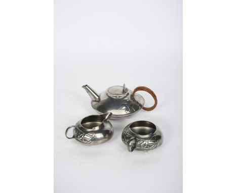 A Liberty &amp; Co English Pewter three piece tea set designed by Archibald Knox, model no.0231, streamlined, compressed form