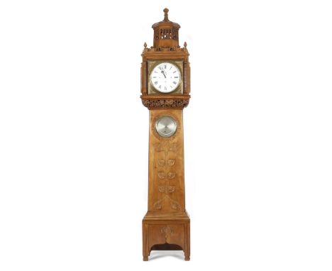 A fine walnut long case clock the design attributed to the Guild of Handicraft to a design by Charles Robert Ashbee,  the clo