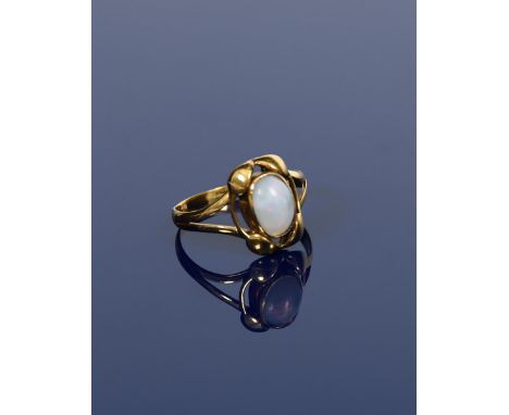 A Murrle Bennett gold ring,  cast with four leaves to the shoulder, set with central opal cabochon, stamped regd mark, size K