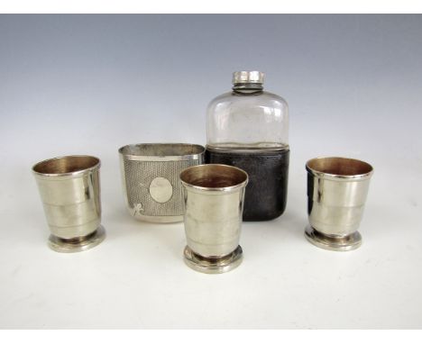 A Victorian electroplate mounted hip flask, together with three parcel gilt collapsible cups