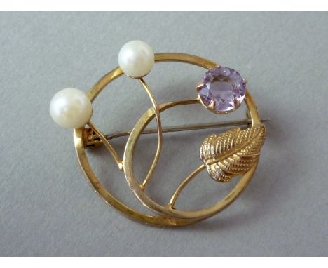 An amethyst and pearl openwork brooch, in a spiralling annular arrangement with extending whiplash stems, the latter terminat