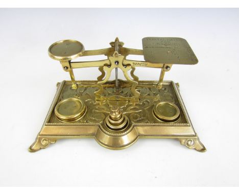 A set of decorative cast brass postal scales with weights, 22 x 14 x 10.5 cm high
