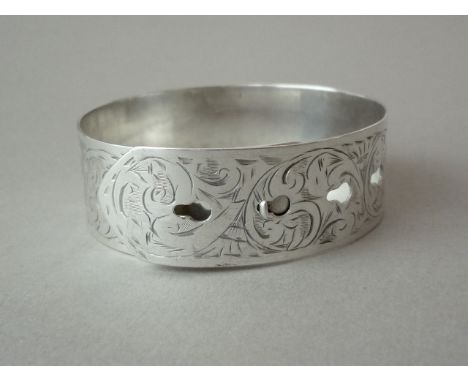 A 1940s silver bangle in the form of a belt, bright cut engraved in a scrolling foliate design, Chester, 1944, 22.8g