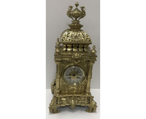 A late 19th Century French Gothic Revival pierced brass cased mantel clock, the eight day movement with silvered chapter ring