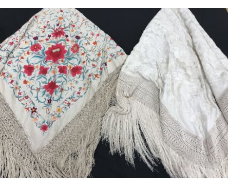 Two piano shawls, one with overall embroidery of foliate design in scarlet, cream, orange and purple, on a cream ground, appr