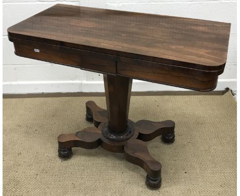 A Victorian rosewood card table, the rounded rectangular fold-over top above a plain frieze above a faceted octagonal column,