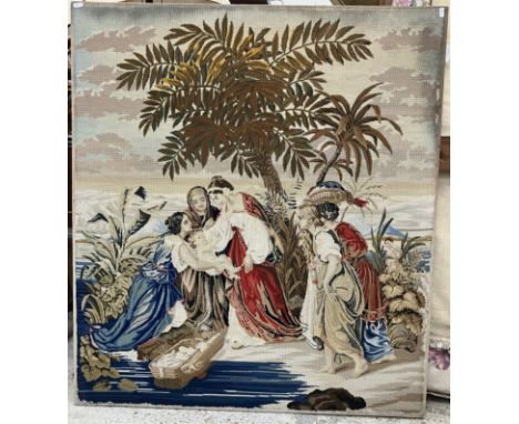 A 20th Century wool work tapestry panel depicting Moses in a basket being retrieved from the bullrushes by the side of the ri