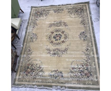 A Chinese style carpet, the central panel set with floral decorated medallion on a gold ground, within a gold and beige, lila