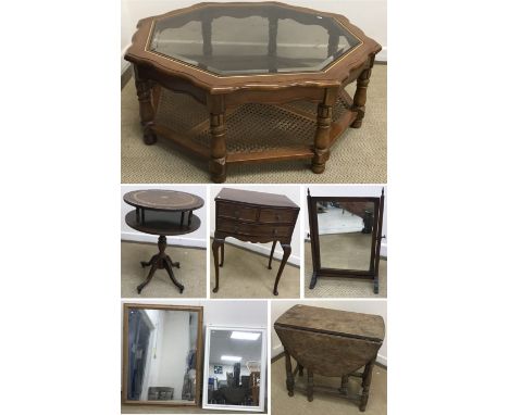 A smoke glass top octagonal coffee table, on turned legs united by a caned undertier, 108 cm diameter x 41.5 cm high, a small