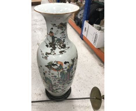 A 19th Century Chinese polychrome decorated vase painted in enamels with figures pouring baskets of flowers over another figu