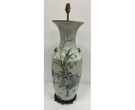 A Chinese polychrome decorated vase depicting figures painting scrolls in a garden setting, signed and bearing character mark