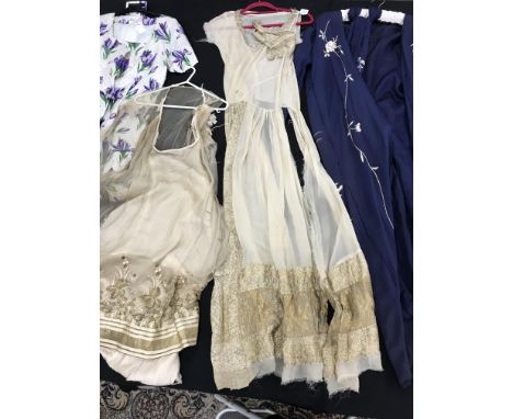 A collection of vintage clothing to include a navy blue Chinese robe with white embroidery, two early 20th Century silk dress