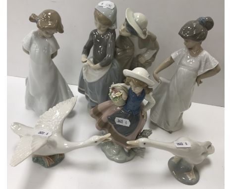 A Lladro figure of "Shepherd Boy and Girl" and two Lladro goose figures, a Lladro figure of "Young girl with basket of flower