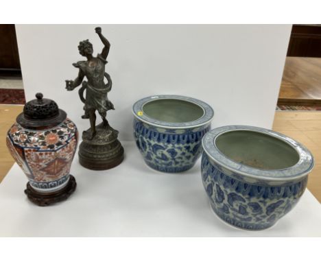 A pair of blue and white jardinieres of small proportions in the Chinese taste set with butterflies to the exterior and carp 