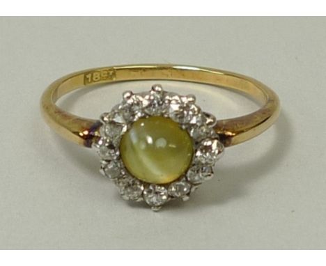 An 18ct gold, cat's eye and diamond ring, approximately 0.4ct, size N. 
