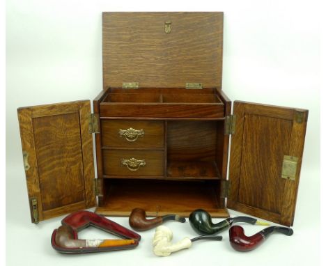 An oak smoker's cabinet, early 20th century, with an interior fitted with drawers and compartments 27 by 16 by 25 high, toget