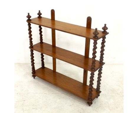 A 19th century three tier mahogany wall shelf, with barleytwist supports, 60 by 15 by 57cm high.