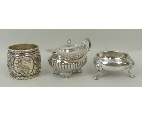 A George II silver circular salt raised on three hoof feet, London 1751, semi fluted mustard pot, London 1914, and a napkin r