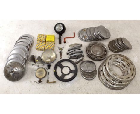 A quantity of early Mini car parts including drive shaft couplings, early pattern, Lucas head lamps, two sets of Mini wheel t