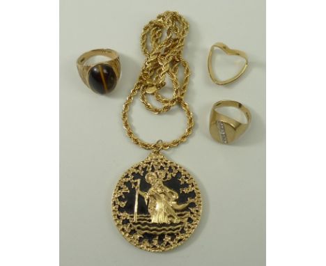 A 9ct gold and black onyx St Christopher pendant, 9ct gold and cabochon tiger's eye ring, size N, 9ct gold and diamond gentle