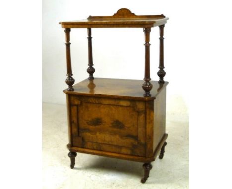 An early Victorian walnut music whatnot cabinet, single shelf with canted corners and shaped upstand, supported on four turne