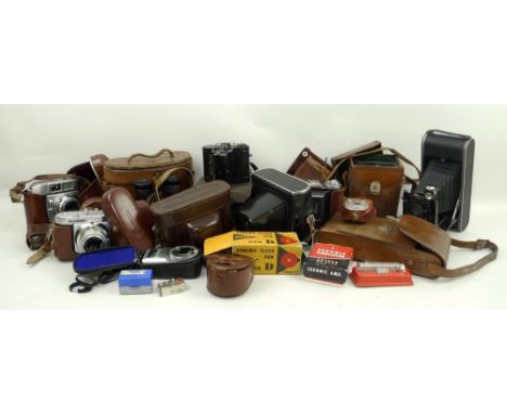 A collection of vintage cameras, including a Zeiss Ikon, Ikonta camera, no 1208, a Voigtlander pronto, a Balda Protor SVS, pl
