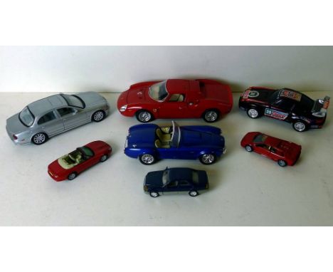 A Burago 1/18 scale Ferrari 250 Le Mans, Cobra 427 1/24, a Welly Jaguar plus four smaller. (7)