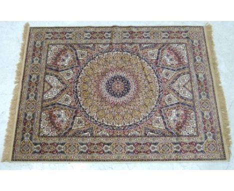 A Pakistani part silk rug with circular central medallion on a cream and light brown ground, 174 by 120cm.