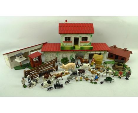 A 1920's toy farm set including painted metal and lead figures, animals, vegetation and farm tools, together with wooden pain