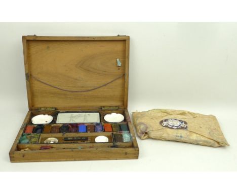 A French, late 19th century, artist's paint box containing two pairs of ceramic dishes and paints, 25 by 18 by 5cm. 