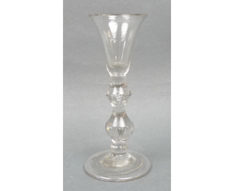 A George I gin glass, circa 1720/30, the trumpet shaped bowl above a double knopped and tear drop stem, raised on a conical, 