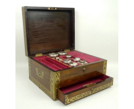 A George IV rosewood and brass inlaid travel box, lock plate stamped Carman, 114 Newgate Street, containing cut glass and sil