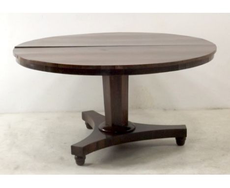 A 19th century rosewood veneered tilt top breakfast table, raised on a tapering hexagonal column and tripod base, on bun feet