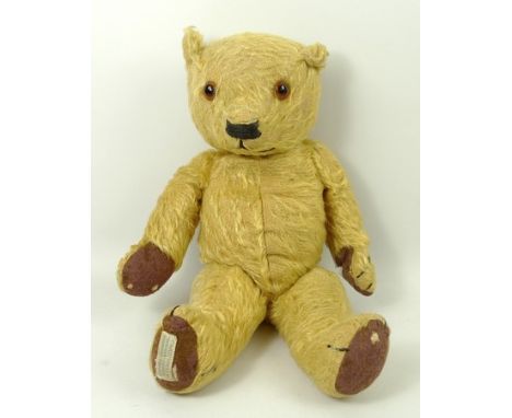 A Chad Valley Magna series bear, circa 1939, with fully jointed, golden mohair body, amber and black glass eyes, stitched nos