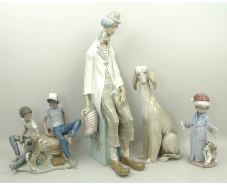 A group of Lladro porcelain figures, comprising; an Afghan hound, 30cm high, melancholy clown, 47cm high, two boys and a pupp