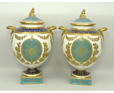 A pair of Wedgwood porcelain vases and covers, late 19th century, of twin handled baluster form, the lid with figural finial,