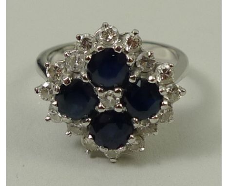 An 18ct white gold, sapphire and diamond cluster ring, diamonds approximately 0.6ct, size O, 6.3g.