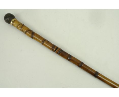 A French bamboo sword stick, turned wooden knob, the blade stamped 'Made in France' and '5', 102cm long. 