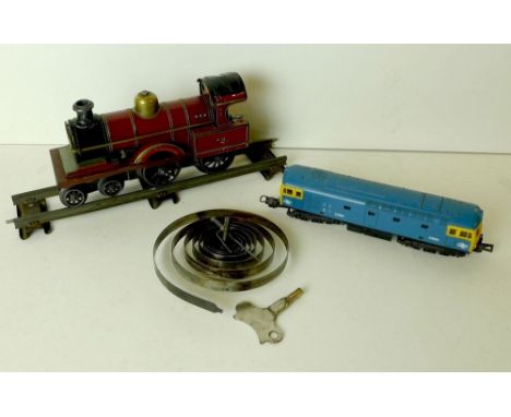 An 'O' gauge tinplate clockwork train with a single piece of track, together with a 'OO' gauge diesel electric engine, Lima, 