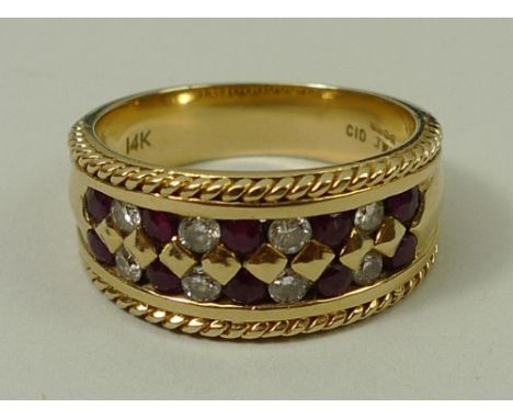 A 14ct gold, ruby and diamond ring in a channeled setting within rope twist borders, size N, 5.9g.