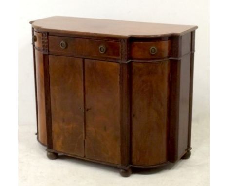 A 19th century mahogany break front cupboard / server, the shaped surface over three drawers with hidden sprung lock, brass r